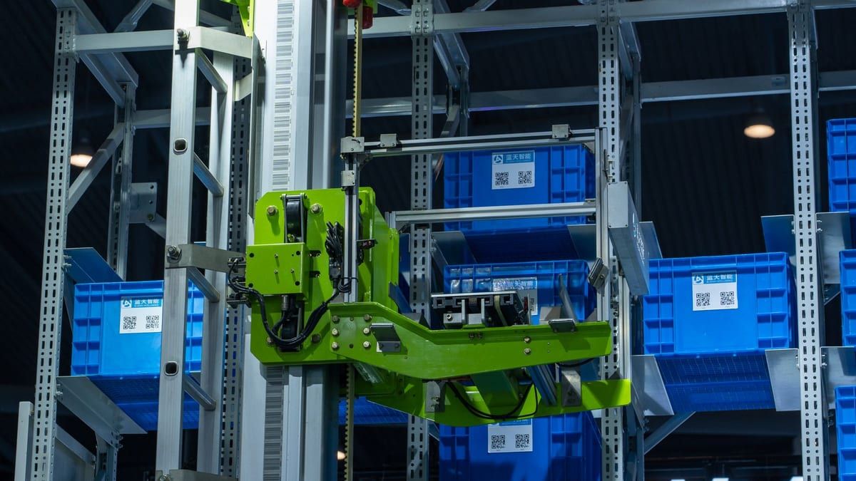 Robot arm handling storage crates in an automated warehouse