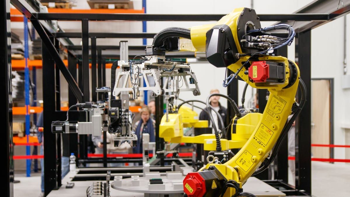 Industrial robot arm working at a manufacturing station
